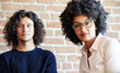 © Trinette Reed/Stocksy - Close-up portrait of two millennials business people at work