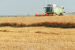 © Borislav Zhuykov/Stocksy - Tractor harvesting grains in crop field