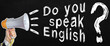 © Dzmitry - A businessman speaks into a loudspeaker, next to the text - Do you speak English. No face visible.