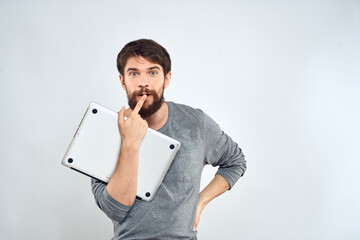 Man with laptop in hands technology internet self-confidence light background