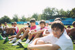 © Lumina/Stocksy - Young Football Players Sitting on the Ground