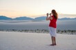 © blurMEDIA/Stocksy - Woman Taking Photo With Phone Camera of White Sand Dunes In White Sands National Monument New Mexico