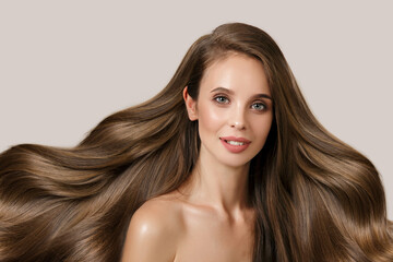 brunette with long wavy thick hair. Hair care and coloring concept