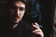 © Katarina Radovic/Stocksy - Portrait of a Handsome Man Smoking Cigarette