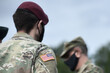 © Bumble Dee - American flag on soldier arm and US soldiers wearing protective face masks. Quarantine in army. Military forces of the United States of America.