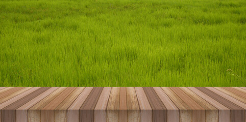 Wall Mural - water drop on green grass and wooden table for product display