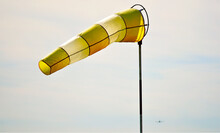 Closeup Of A Yellow And White Windsock Floating In The Air During Daylight