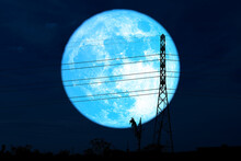 Super Harvest Blue Moon And Silhouette Power Electric Pole In The Night Sky