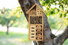 Decorative Insect House With Compartments And Natural Components In A Summer Garden. Wooden Insect House Decorative Bug Hotel, Ladybird And Bee Home For Butterfly Hibernation And Ecological Gardening.