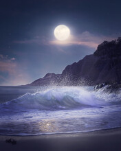 Vertical Shot Of Sea Waves On A Beach Next To The Mountains Under The Bright Moonlight