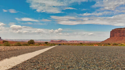 Wall Mural - Countryside road through the fabulous Monument Valley in summser season, aerial view from drone