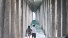Long Perspective Of Couple Under The Pier.
