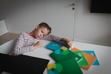 Wall Mural - Child tired and bored of doing homework, kid stressed from learning indoors