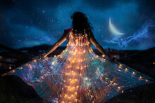 Belly Dancer With Wings Of Light Under A Starry Sky