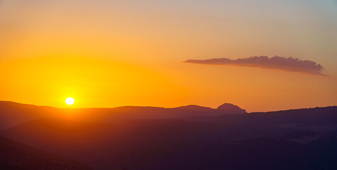 Wall Mural - orange sunset sunrise with cloud and mountains in silhouette