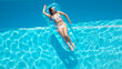 © 4kclips - Sunbathing and tanning in a swimming pool - top down view