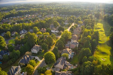 Wall Mural - Beautiful aerial view of an upscale sub division in Suburb with Golf course and a lake shot during the golden hour