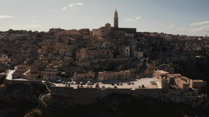 Wall Mural - Aerial panoramic view of the ancient town of Matera (Sassi di Matera) in beautiful golden morning light at sunrise, Basilicata, southern Italy. Gorgeous old town from above. Magical Italy.