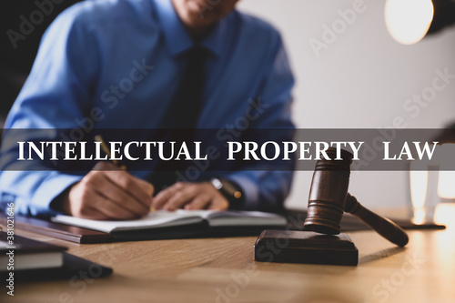 Intellectual property law. Jurist working at table in office, focus on gavel
