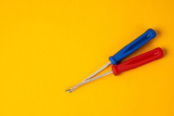 screwdrivers and construction tools on yellow background equipment for repair industry