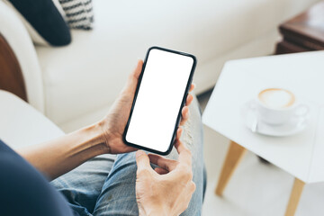 cell phone mockup blank white screen.woman hand holding texting using mobile on desk at coffee shop.background empty space for advertise.work people contact marketing business,technology