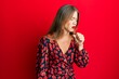 © Krakenimages.com - Beautiful young blonde woman wearing elegant dress feeling unwell and coughing as symptom for cold or bronchitis. health care concept.