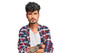 Young hispanic man wearing casual clothes skeptic and nervous, disapproving expression on face with crossed arms. negative person.