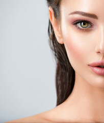 Wall Mural - half face of a woman with healthy skin of face. closeup fresh face of an attractive caucasian girl. 