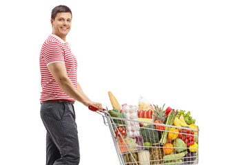 Man with a shopping cart smiling at the camera