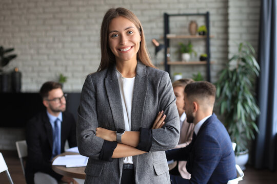 business woman with her staff, people group in background at modern bright office indoors.