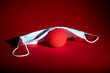 © Stockhausen - a red foam nose lies under a face mask, symbol for the restriction to carnival due to corona virus
