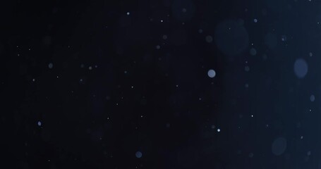 Floating abstract particle bokeh on dark background
