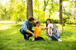 © BGStock72 - Beautiful happy family is having fun with bichon dog outdoors