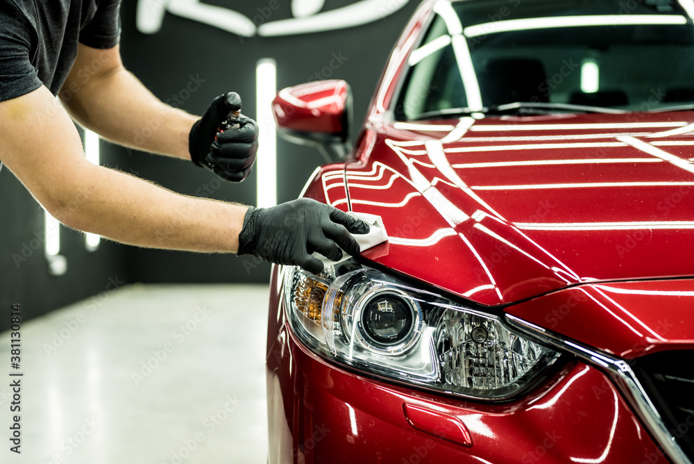 Car service worker applying nano coating on a car detail. - obrazy, fototapety, plakaty 
