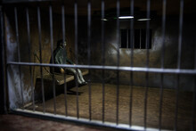 Jail Or Prison Cell. Man In Prison Man Behind Bars Concept. Old Dirty Grunge Prison Miniature. Dark Prison Interior Creative Decoration. Selective Focus