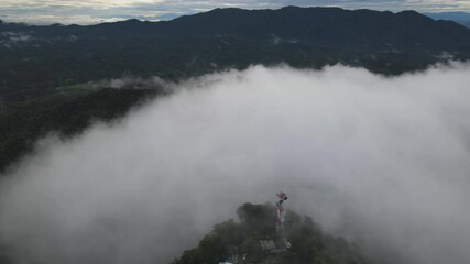 Wall Mural - Aerial view, Beautiful Panorama landscape sunrise over peak Mountain with mist and warm light sunrise at signal repeater station pole,  Communication technology concept. Mae Moh Lampang, Thailand.