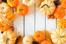 Autumn Frame Of Pumpkins And Fall Decor. Top View On A Rustic White Wood Background With Copy Space.