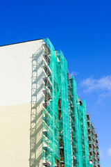 Wall Mural - scaffolding arround the house to install thermal insulation of the apartment building facade