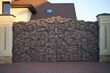 © pridannikov - Luxurious metal wrought iron gates on a wooden base with decorative elements