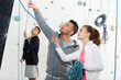 © auremar - instructor showing young climbers the ropes at indoor wall