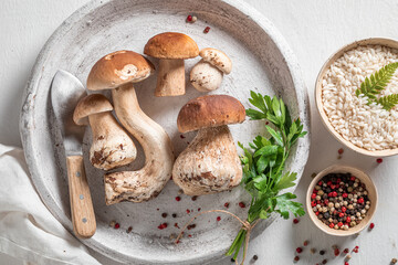 Wall Mural - Ingredients for homemade risotto made of wild mushrooms and herbs