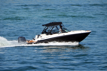 High-end black and white motor boat speed across Biscayne Bay off of Miami Beach,Florida