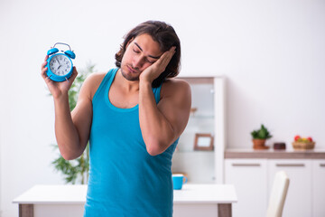 Wall Mural - Young man waking up at home