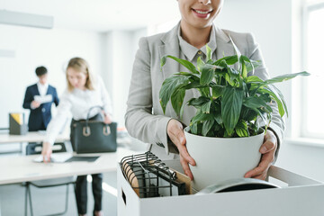 Wall Mural - Happy young businesswoman in formalwear taking out office supplies out of box