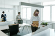 © pressmaster - Group of contemporary business people taking out office supplies out of boxes