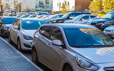 Canvas Print - Cars in a parking lot in a residential area