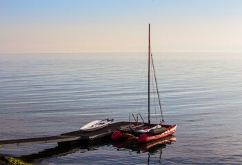 Wall Mural - Sailing catamaran at the pier at sea