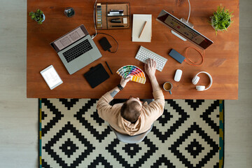 Wall Mural - Top view of young contemporary freelance software developer making logo