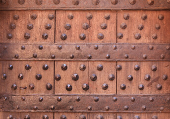 Antique oak door with metal rivets