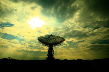 The silhouette of a radio telescope observatory